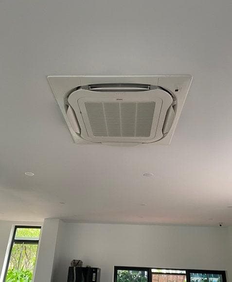Ceiling cassette mini split installed flush in a finished ceiling